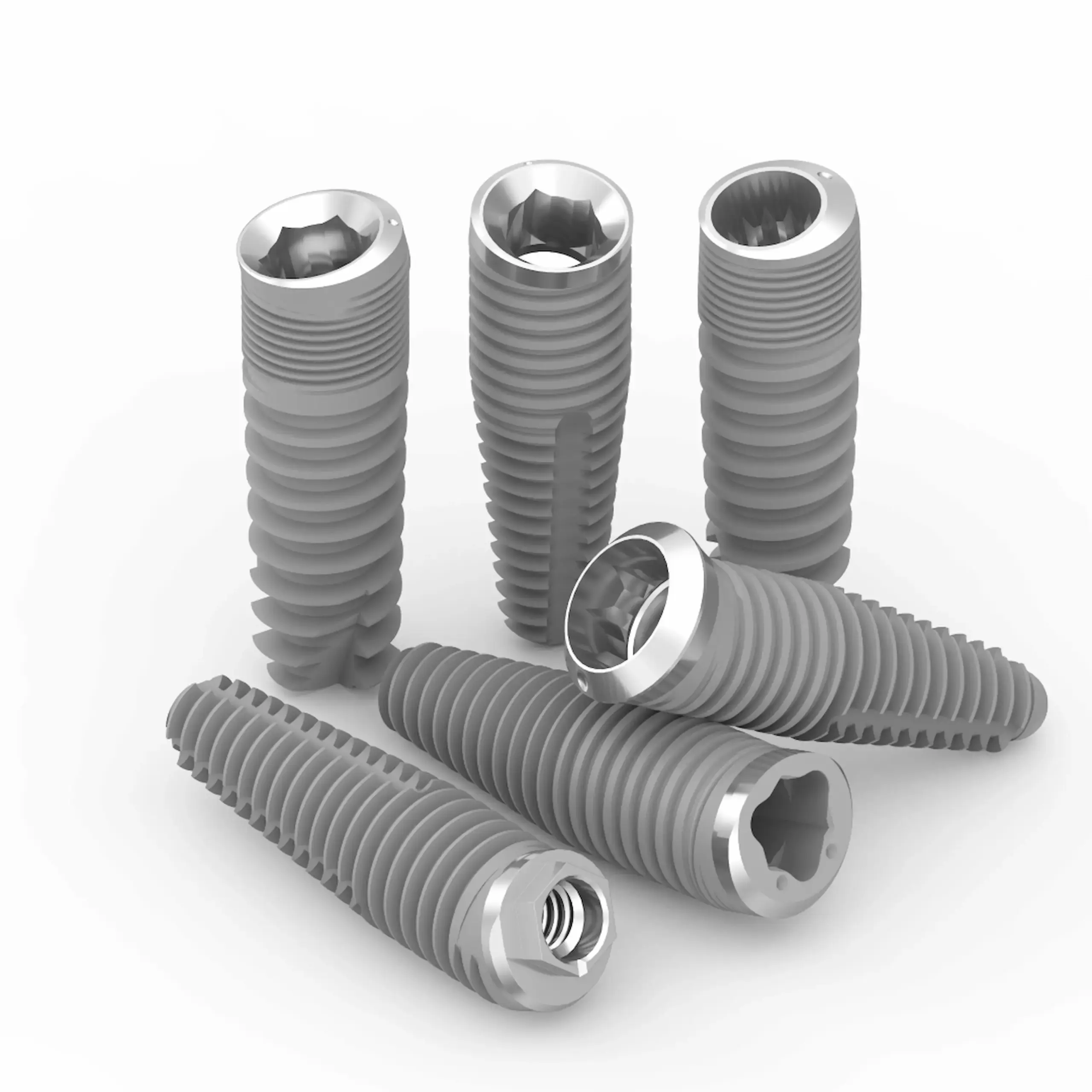 Vis dentaires implantées en groupe sur fond blanc.
